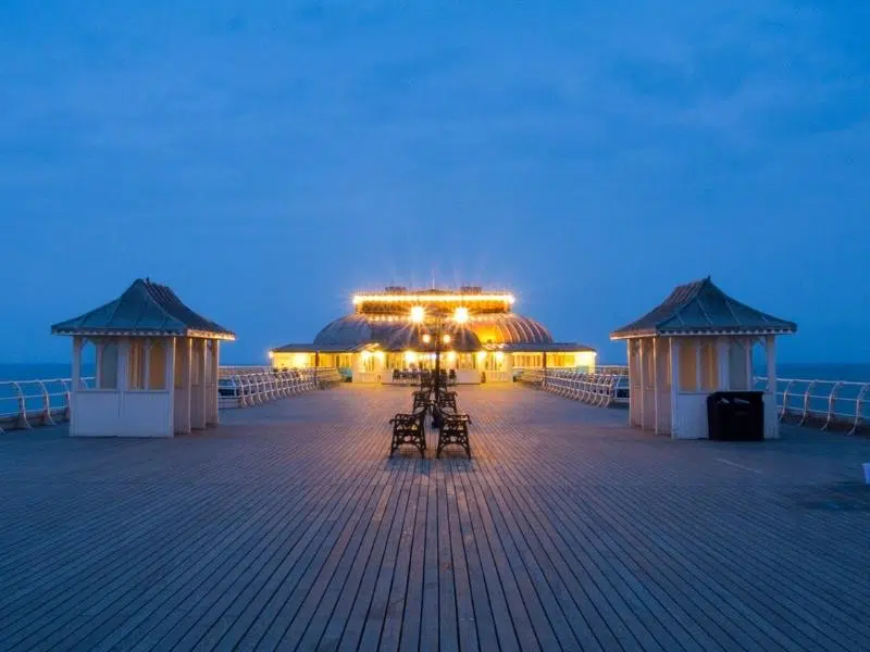 grand pier end theatre lit up at dusk