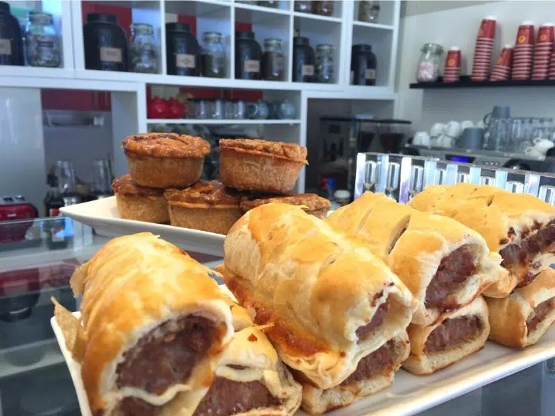 Close up image of pastry covered sausage rolls and pork pies