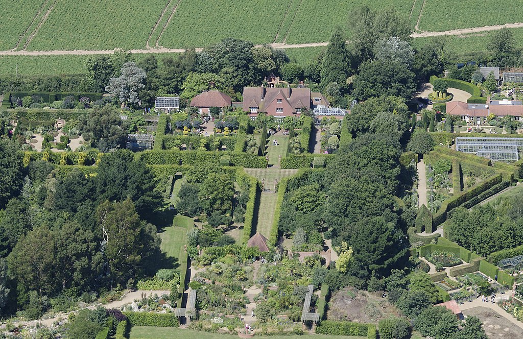 aerial view of large formal gardens and a arts and crafts house