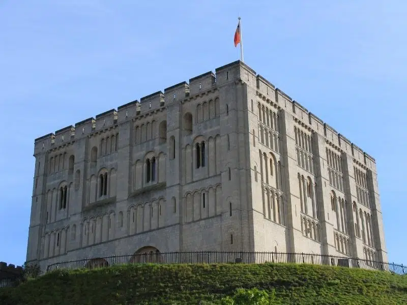 Large stone Normal castle on a grassy mound with blue sky