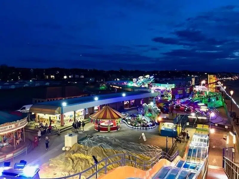 Funfair with bright lights at night