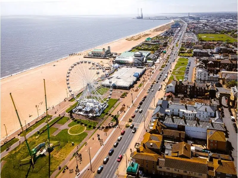 long sandy beach with fairground