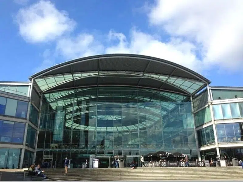 modern glass and steel building with steps in front