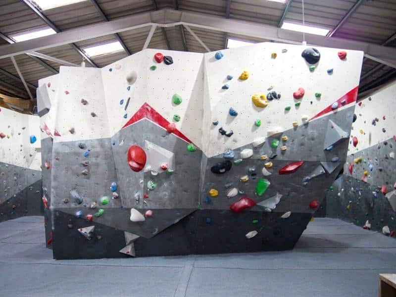 indoor climbing wall with different coloured holds