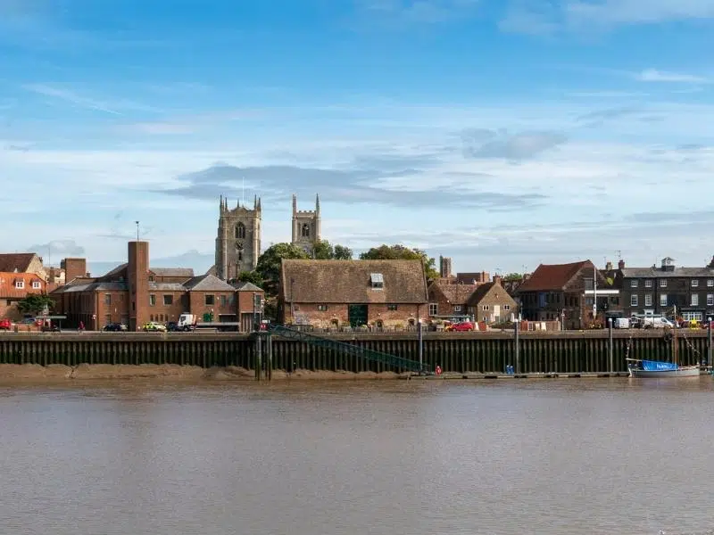 church and other historic buildings on a riverside quay