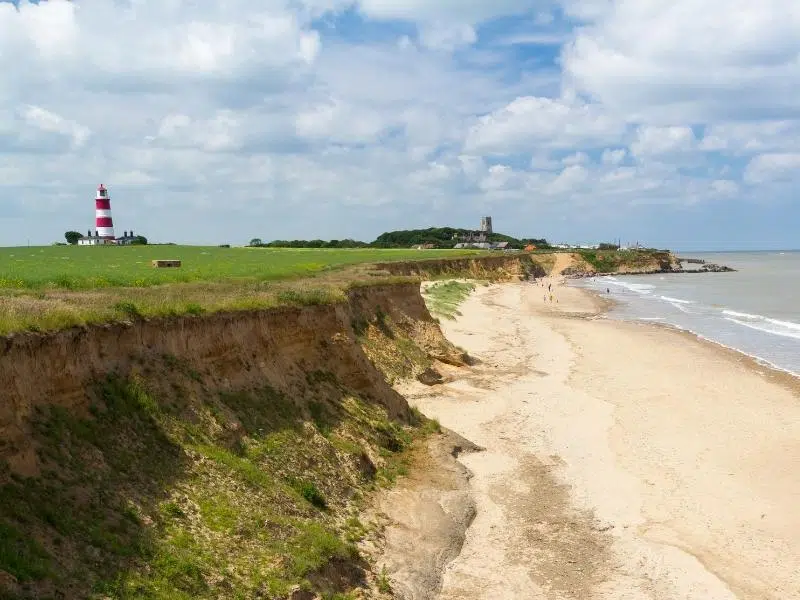 Happisburgh Beach with lighthouse and church in the distance