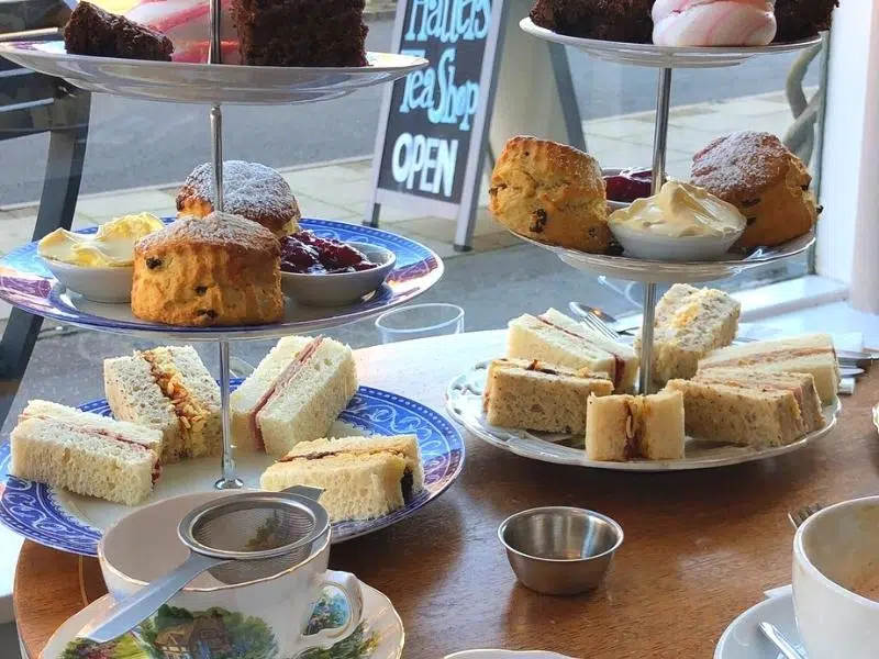 tea stand sandwiches, scones and cakes on a table in a cafe 