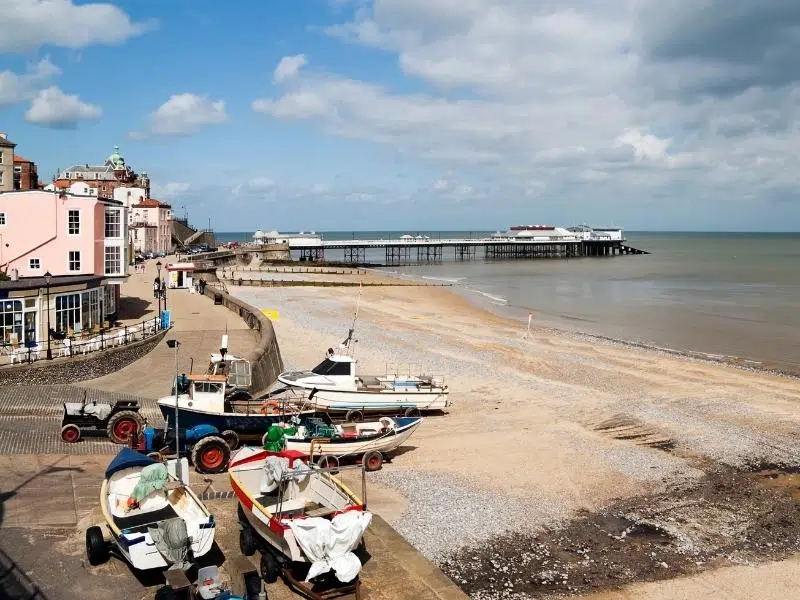 Fishing boats on Cromer beach with the town and pier behind