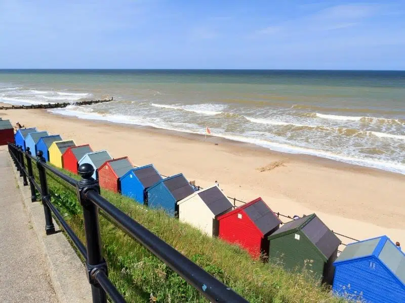 Colourful wooden beach uts on the beach front