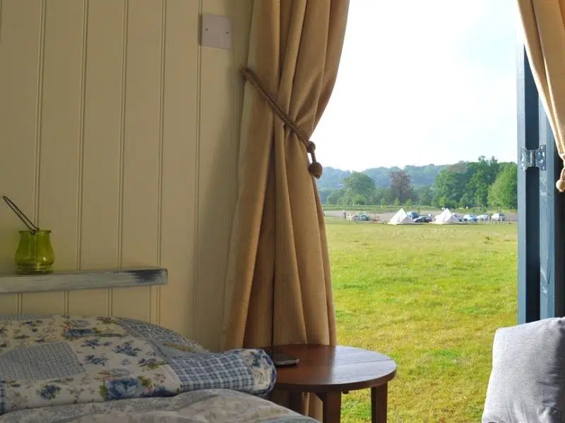 View to bell tents from a restored railway carriage