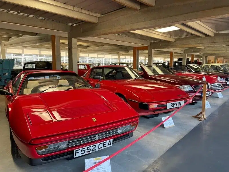 red sports cars in a museum