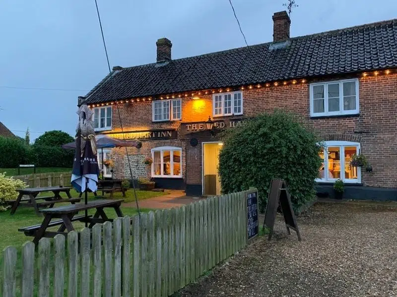 Pub at night with lights shining through wndows