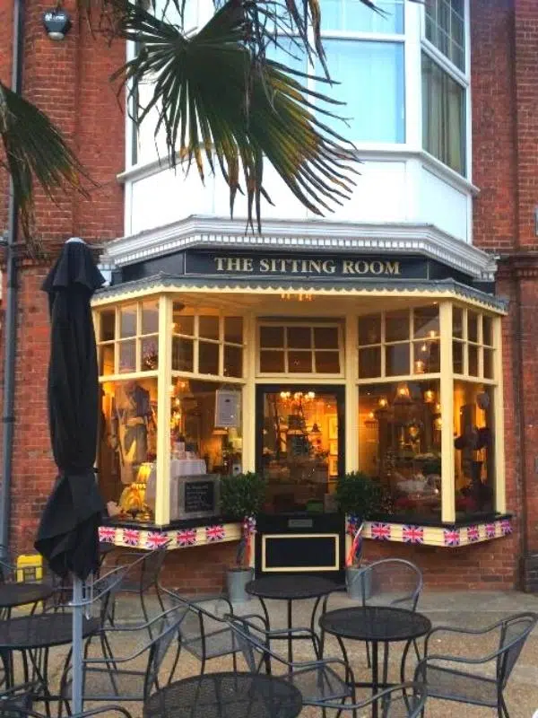 Outside of a Sheringham cafe with bow windows and outdoor seating