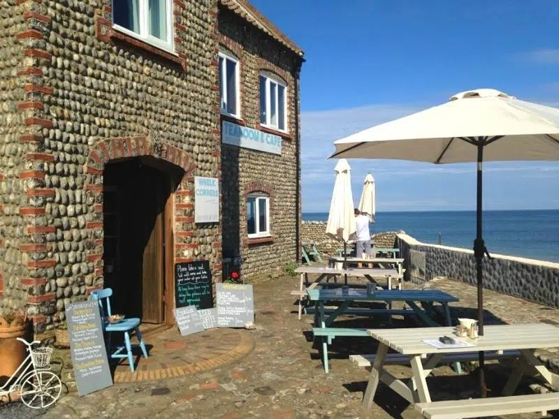 outside dining area with benches and umberellas overlooking the North Sea