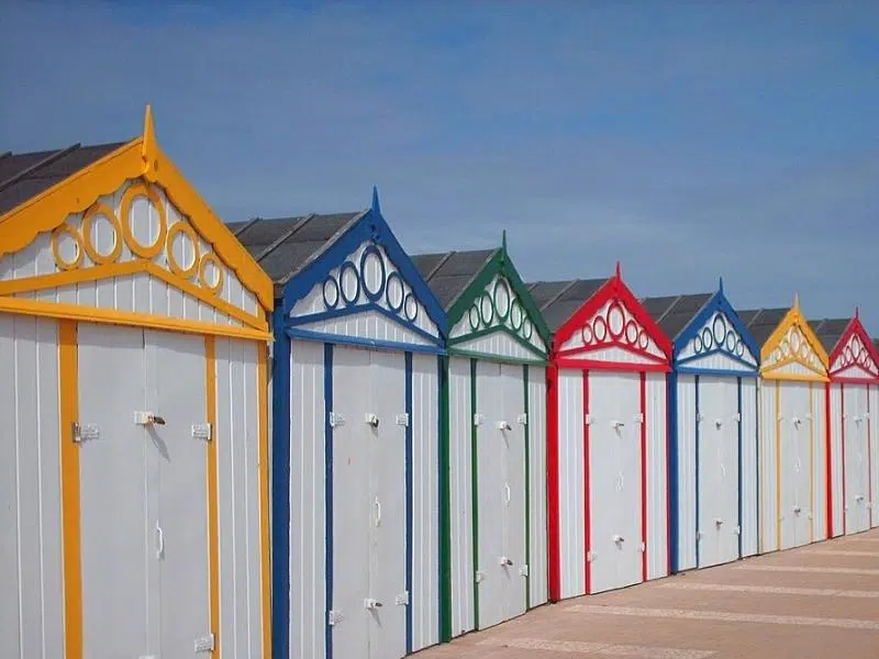 wooden white and primary colour beach huts