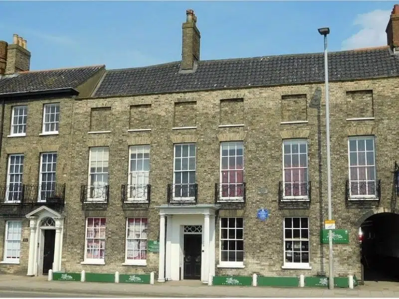 historic town house with Georgian features and a white porticoed entrance