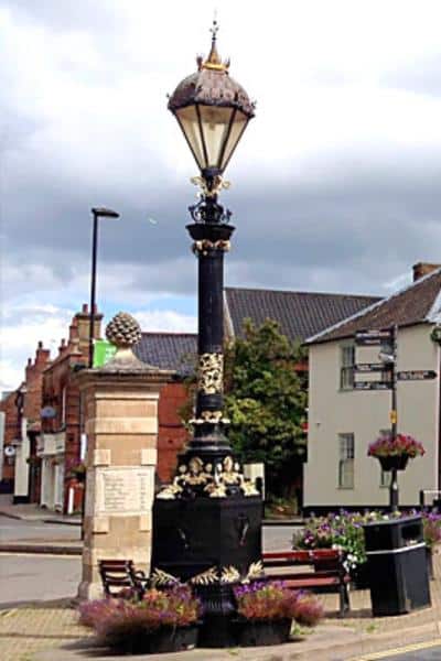 Victorian lampost and stone pillar with a pineapple top