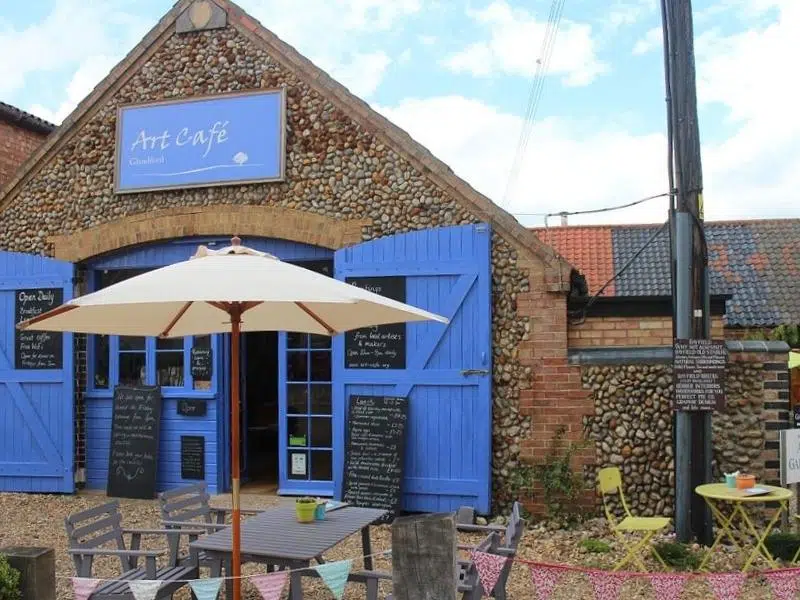 Pebbled barn with blue windows and doors