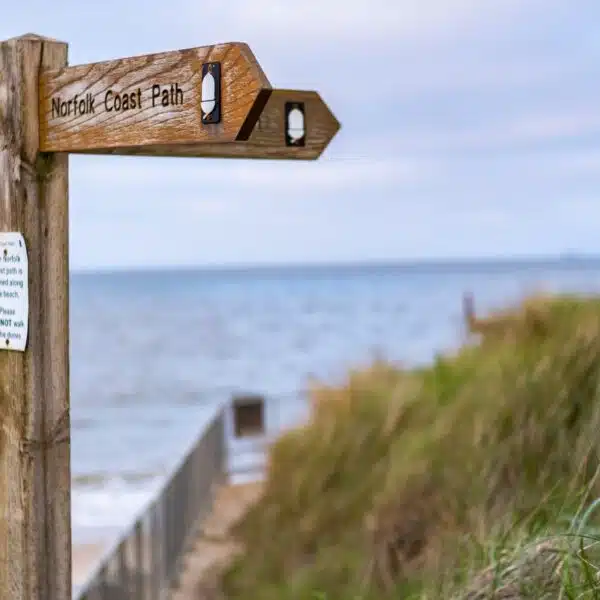An image of a sign post with the words Norfolk coast path