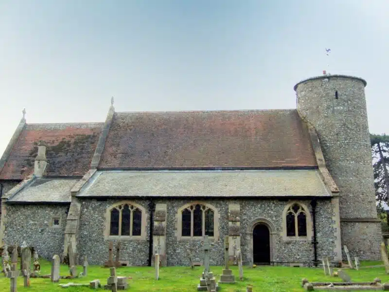 A small flint church with a round tower