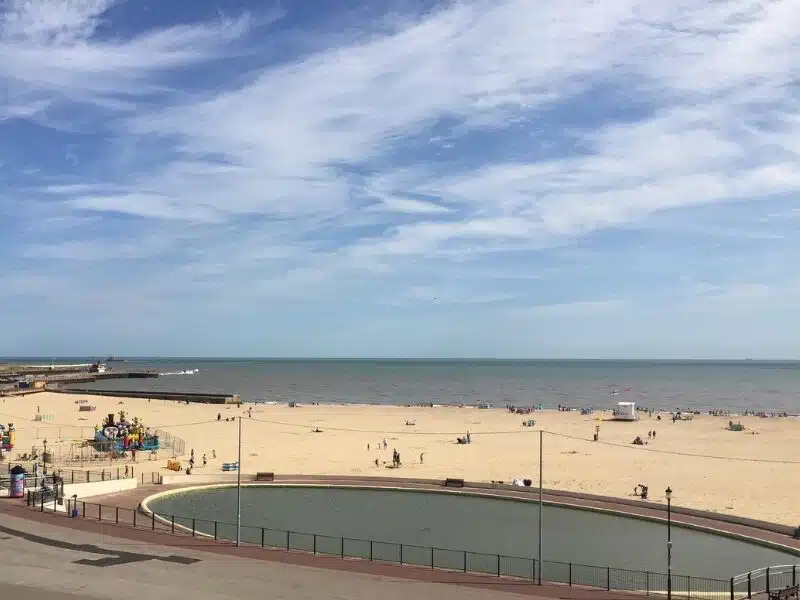 small pond between promenade and beach