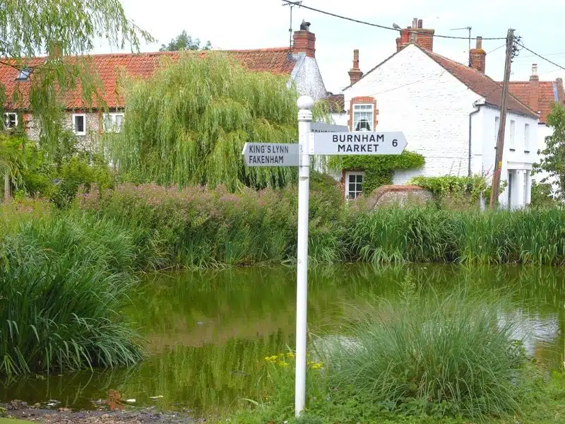 Norfolk road sign by a village pond