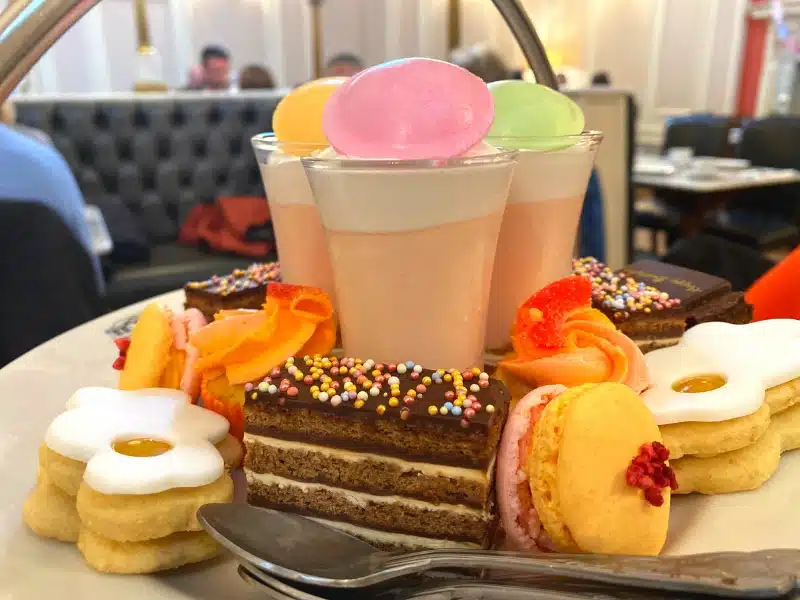 Cake stand of brightly coloured cakes and sweets
