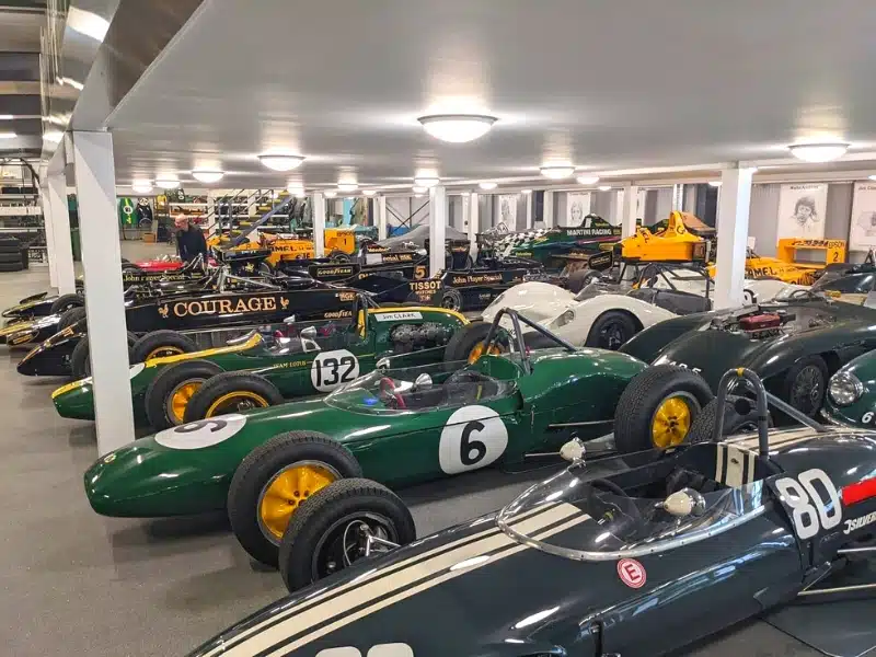 Racing cars together in a large garage