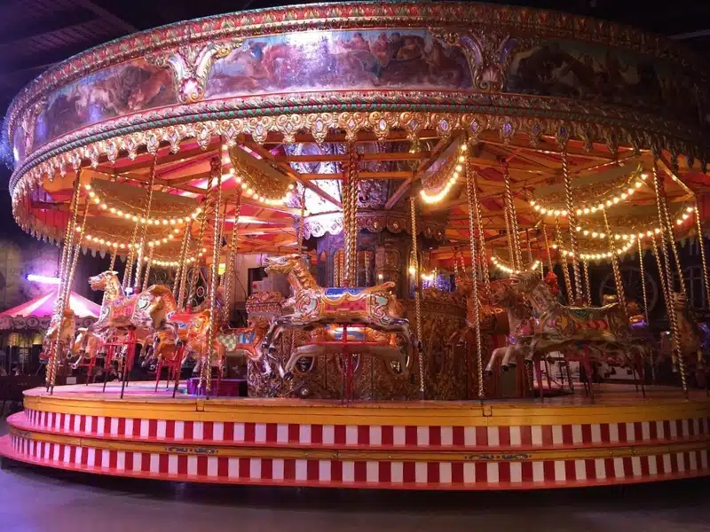 Colourful fairground carousel with painted horses