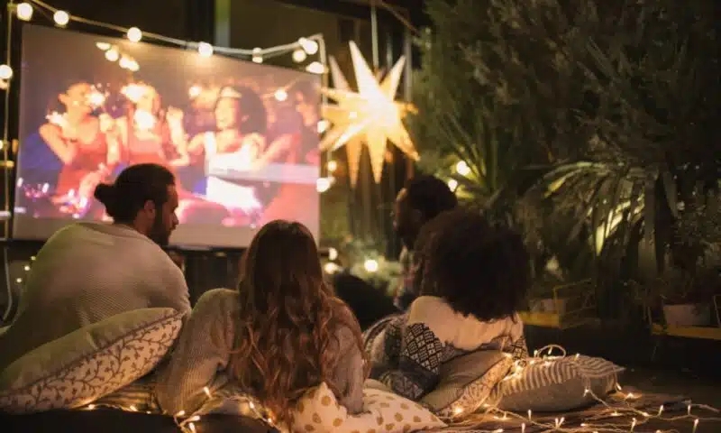 People watching an outdoor cinema screen