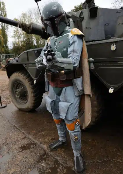 person dressed up in front of a tank