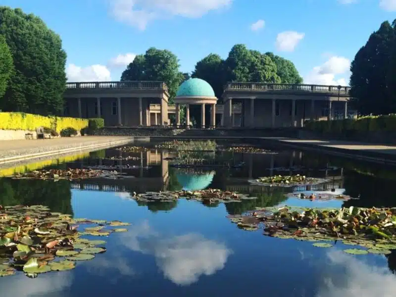 ornamental lily pond in front of copper domed bandstand