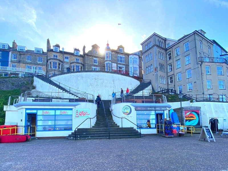 surf schools along a promenade backed by houses